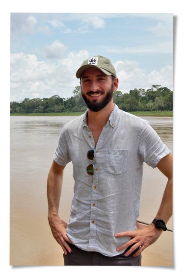 Ryan Bartlett stands outside on riverside