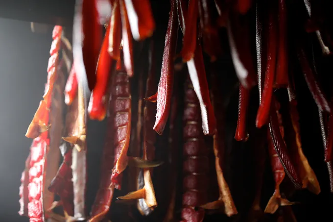 Closeup of salmon hanging in a smokehouse