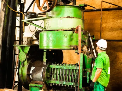 A man stands next to large machine