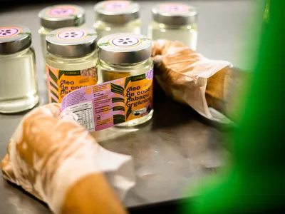 Hands placing labels on jars
