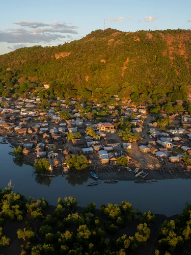 Landscape photo looking down on river village with mountain in background