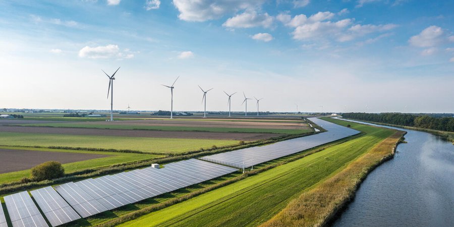 Solar panels and wind turbines generating renewable energy for green and sustainable future. Netherlands.