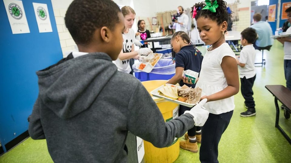 Students holding trays in a lunch line