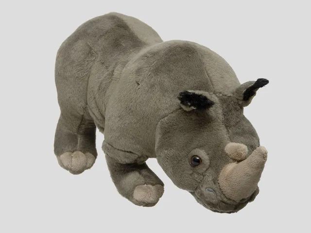 An African rhino plush against a gray background