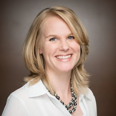 Headshot of Amelia Landers in a white shirt and necklace with blonde hair