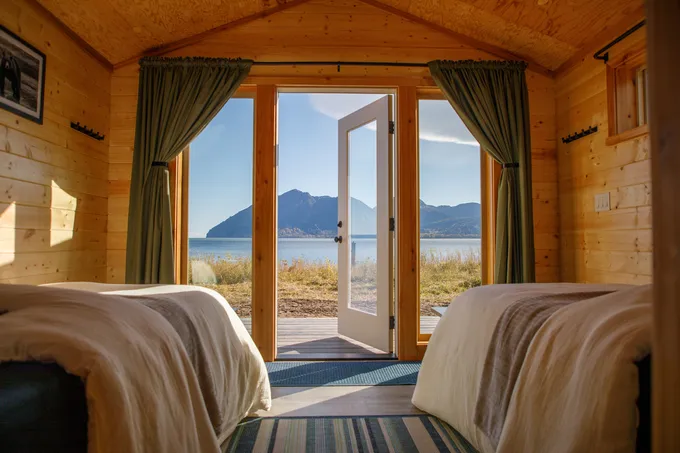 Looking out through a cabin door at the Alaskan landscape