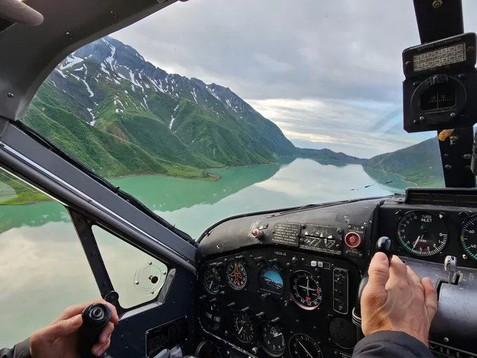 The cockpit of a small plane, flying over Alaskan landscape