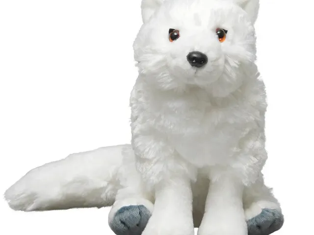 Arctic fox plush against a white background