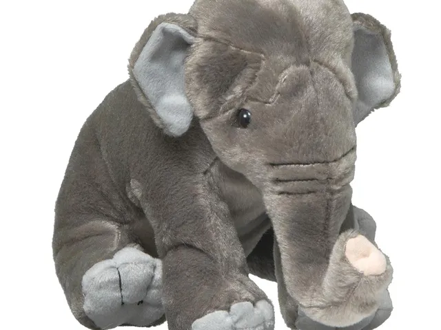 An Asian elephant plush against a white background