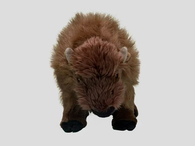 A bison plush against a gray background