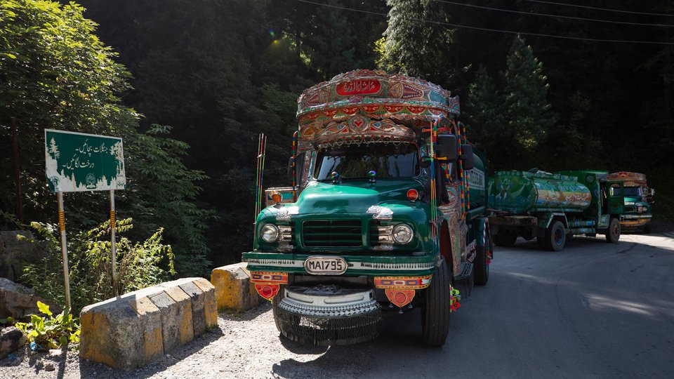 A colorful tanker truck on the side of a road