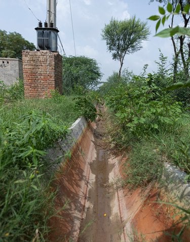 A dry cement-lined channel for water irrigation