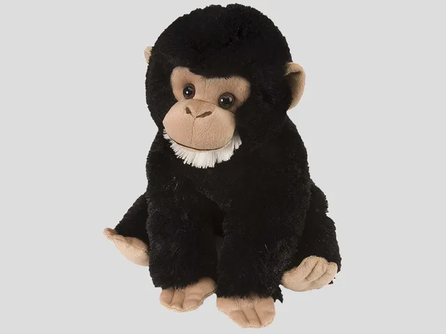 Chimpanzee plush against a gray background
