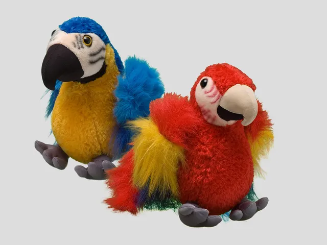 A red and blue macaw plush against a gray background.