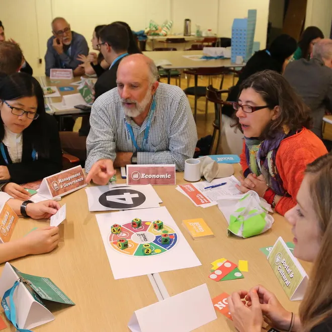 People around a table playing a board game