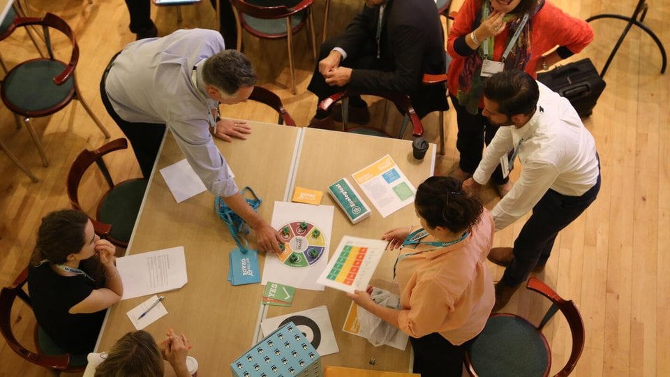 People around a table playing Get the Grade