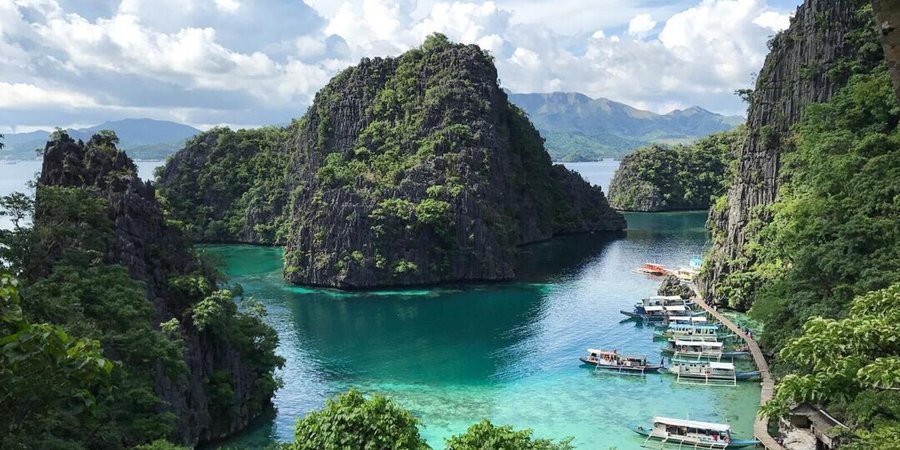 View of green forested mountains and blue water