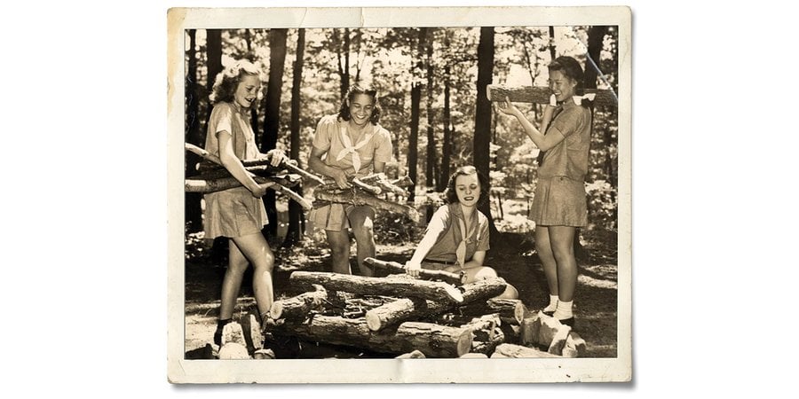 Old photo of Girl Scouts building a fire