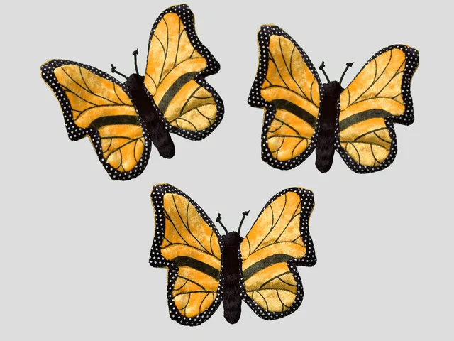 Three monarch butterfly plush against a gray background