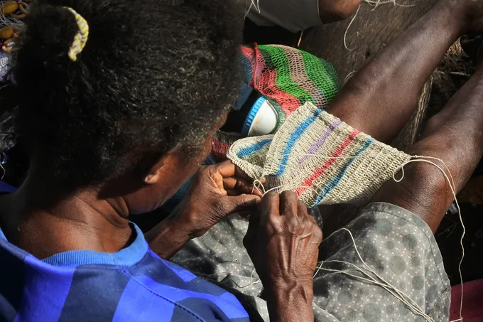 Woman hand weaving bag