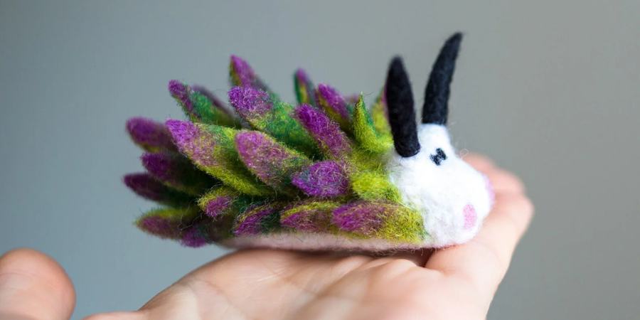 Colorful wool sculpture of a nudibranch species (Costasiella kuroshimae)