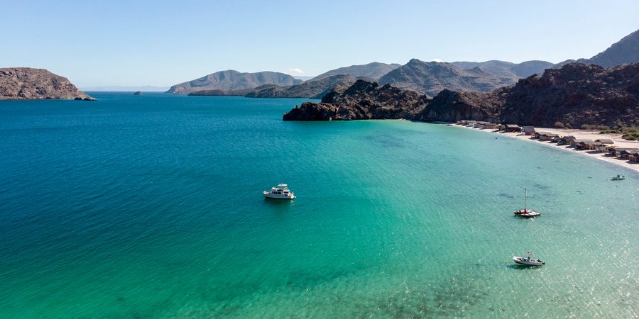 Aerial photo of ocean cove with boats