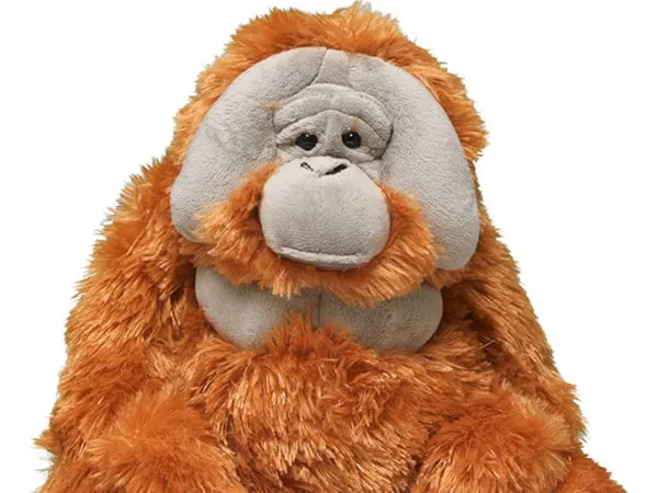 A male orangutan plush against a white background