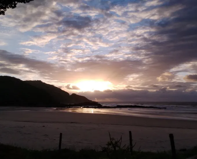 A sunset over the ocean and land