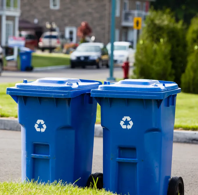 Blue recycling bins on a curbside