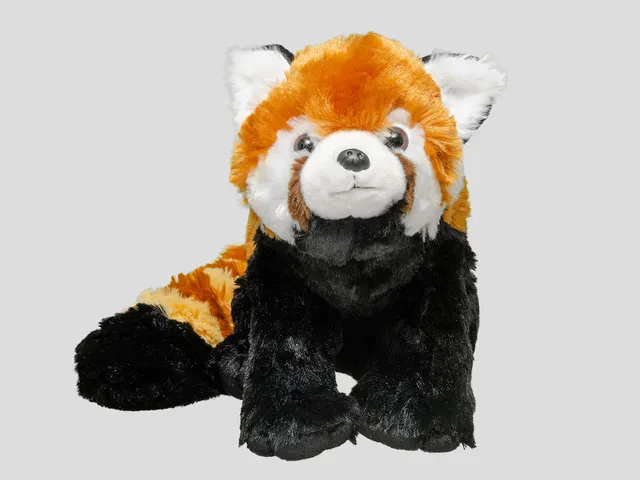 A red panda plush against a gray background
