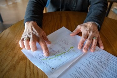 Hands holding a diagram on a table