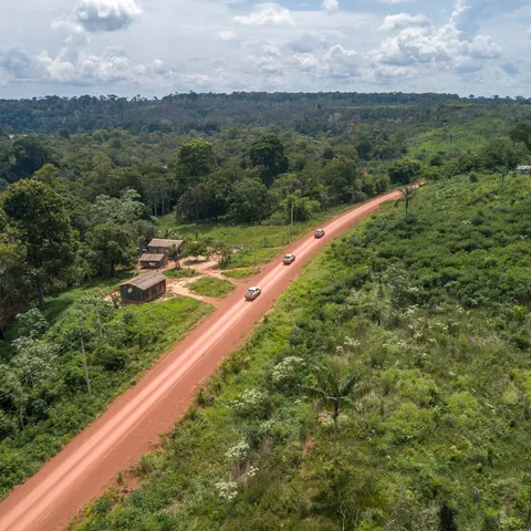 A dirt road traveling into jungle area