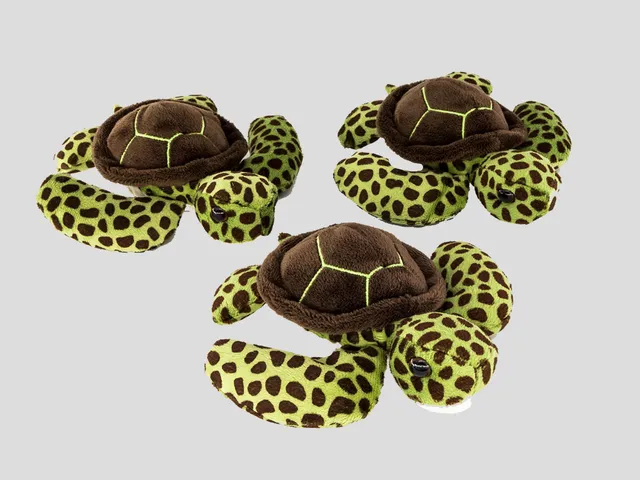 Three sea turtle hatchling plush against a gr aybackground