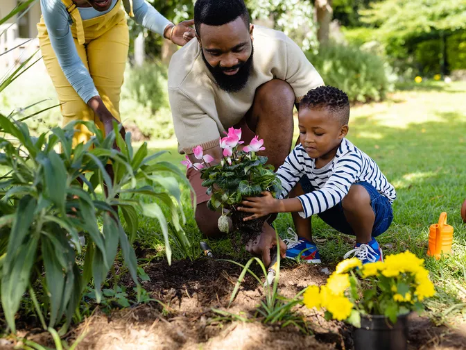 Father and sun gardening outside
