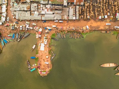 Aerial photo of a small port with ships and loading goods