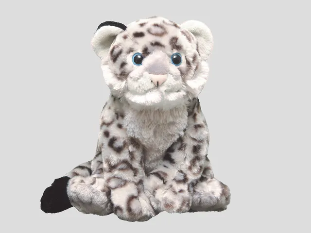 A snow leopard plush against a gray background