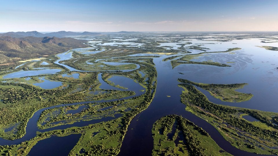 Aerial view of the Pantanal Matogrossense National Park with Amolar Mountain Ridge in the background. on a sunny day