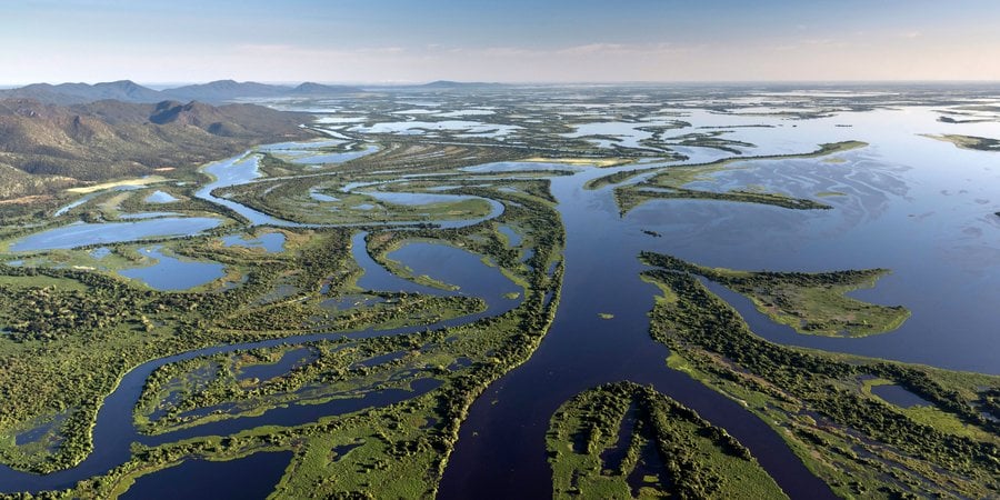 Aerial view of the Pantanal Matogrossense National Park with Amolar Mountain Ridge in the background. on a sunny day