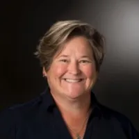 A headshot of a woman smiling at the camera
