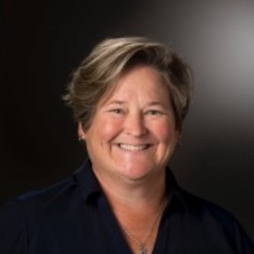 A headshot of a woman smiling at the camera