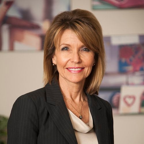 A headshot of a woman dressed formally