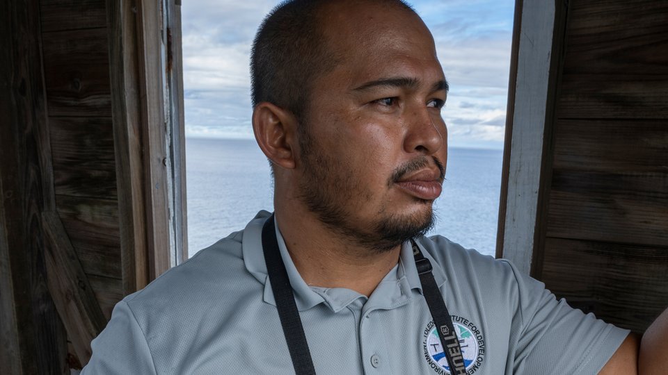 Cabrera stands in window with binoculars
