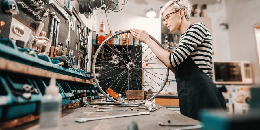 A person working on a bicycle wheel
