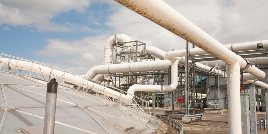 large pipes leading from a biogas tank to a processing plant