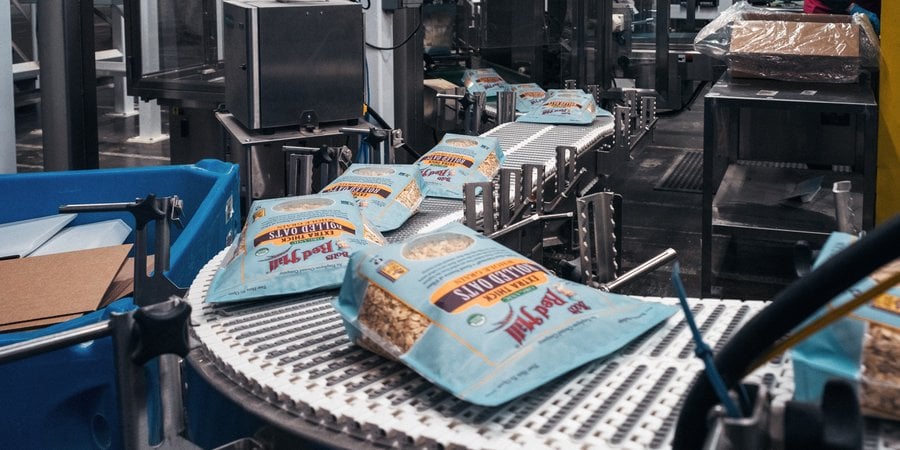 Bags of Bob's Red Mill rolled oats travel down a manufacturing line