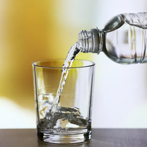 Bottled water pouring into glass