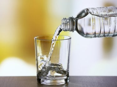 Bottled water pouring into glass