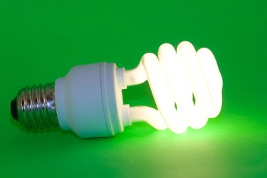 A common flourescent bulb, lit and laying on its side