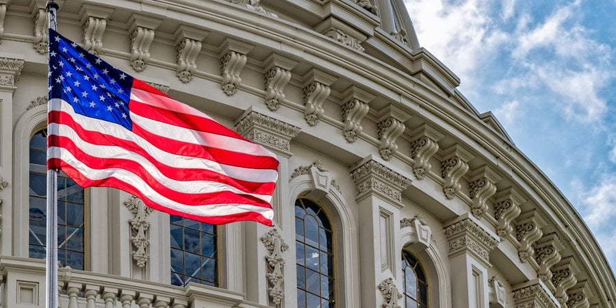 Washington DC Capitol dome detail with waving american flag