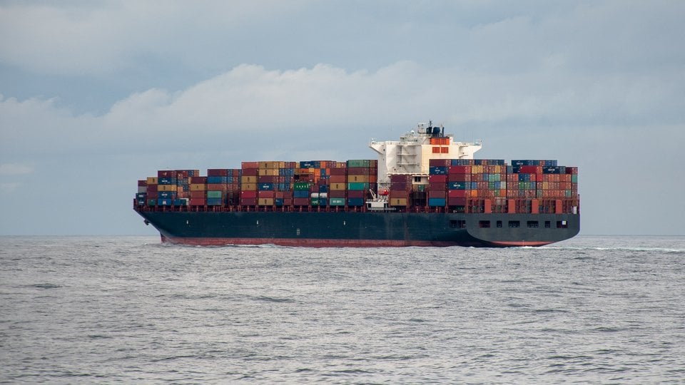 A container ship fully loaded sails through the north Atlantic